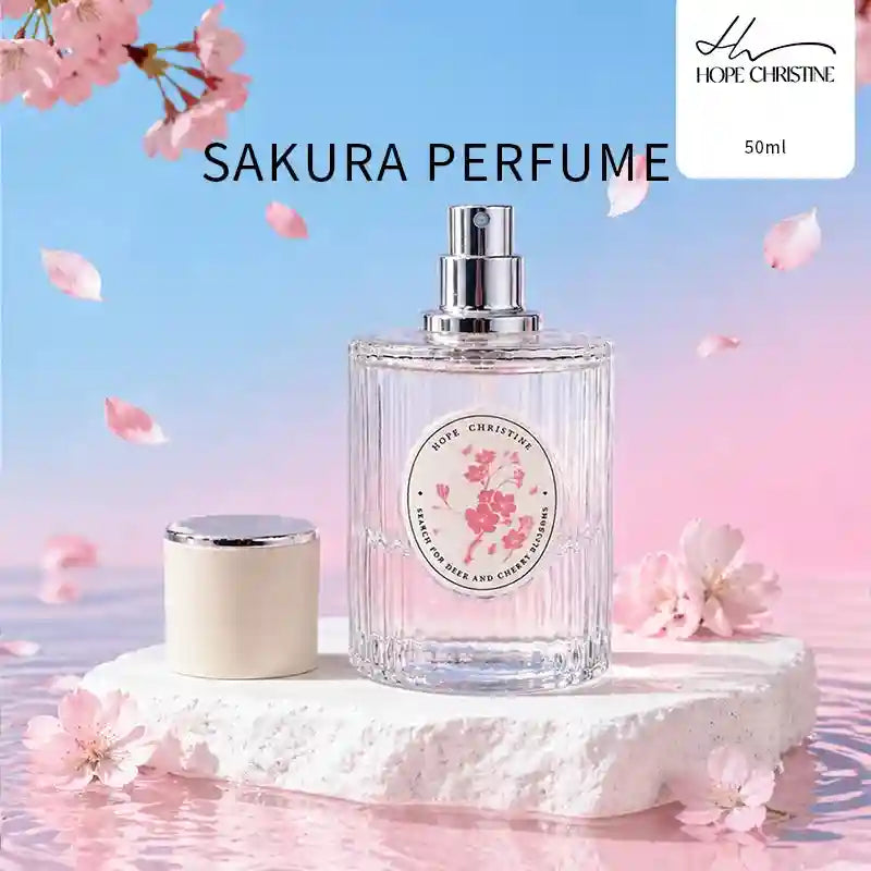 50ml Sakura perfume in a cylindrical, ribbed glass bottle with a white cap, displayed on a textured white stone.