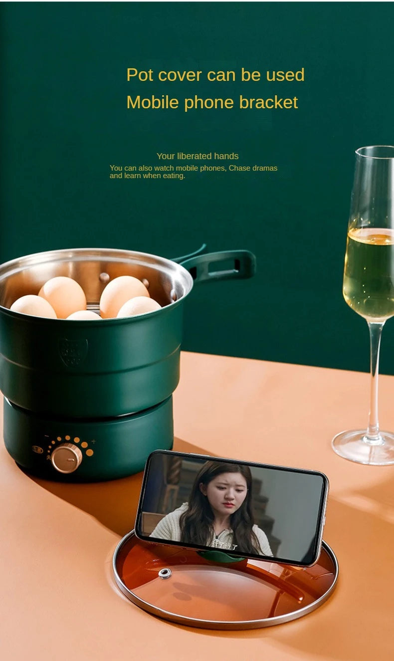Green electric multi-cooker with lid used as phone stand; pot with eggs inside