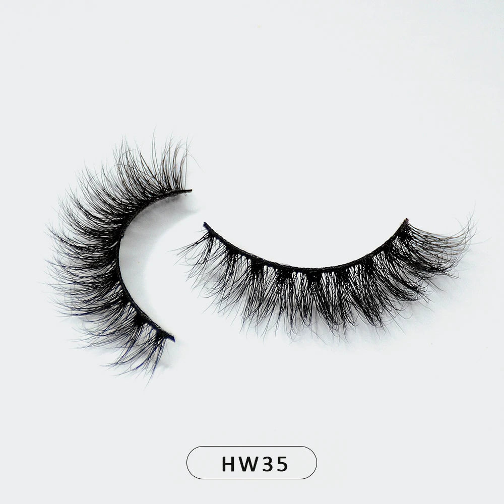 Pair of fluffy black 3D mink false eyelashes with a flexible band on a white background, labeled HW35.