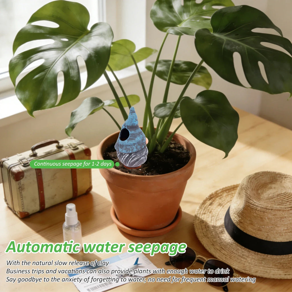 Blue ceramic self-watering spike insert in a terracotta planter with houseplant