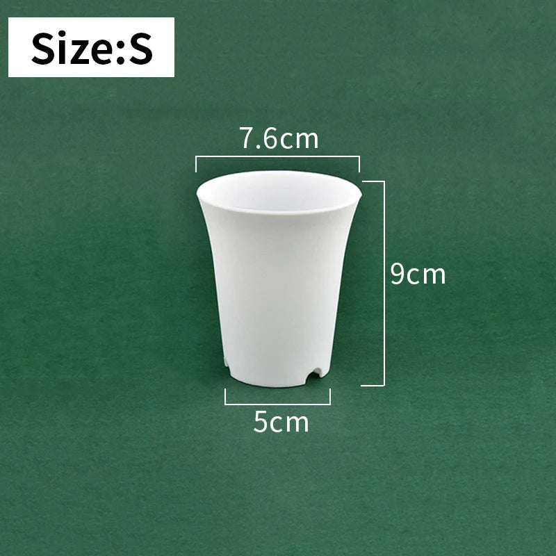 Small white plastic nursery seedling pot, tapered sides and drainage holes