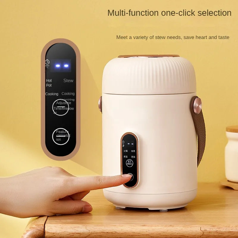 White electric stewing cup slow cooker with handle and finger pointing at controls