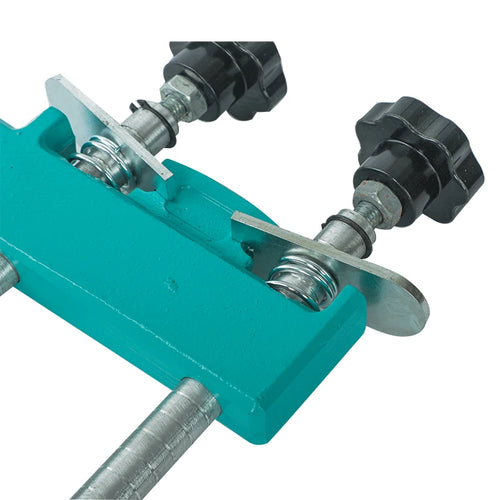 Close-up of green stone mitre clamp with two bolts and black adjustment caps