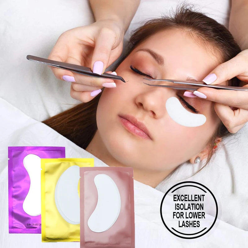 Lint-free white under-eye patches for eyelash extensions in colorful purple, gold, and pink foil packaging.