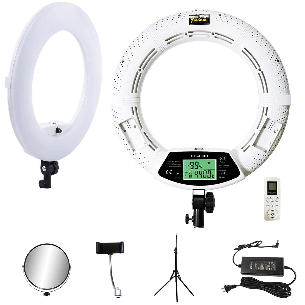 White circular LED ring light for photography and video with digital display, remote, tripod, mirror, and power adapter.