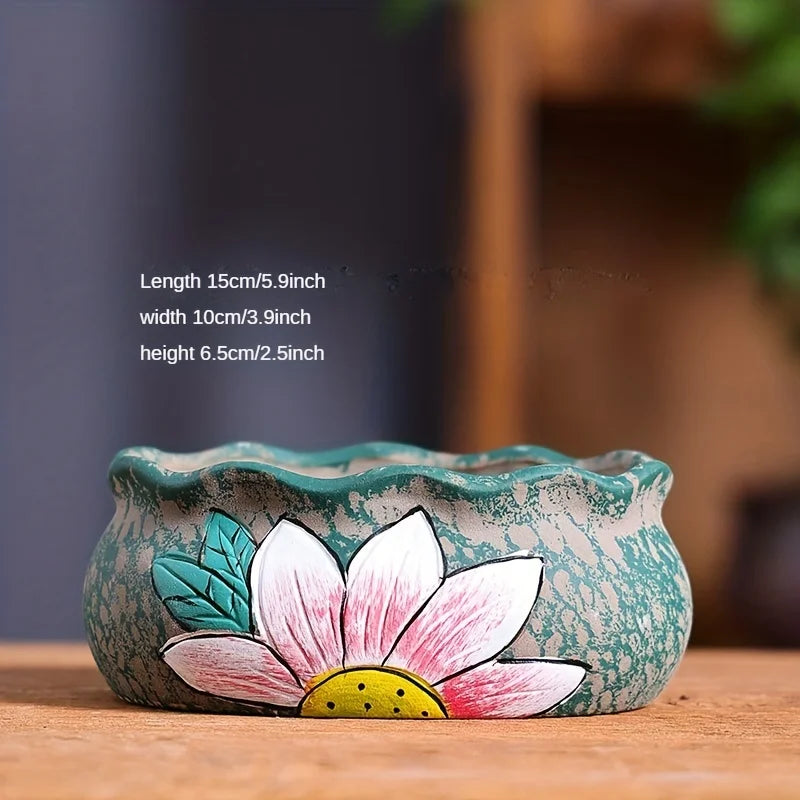 Turquoise ceramic oval planter with speckled texture and painted pink lily flower