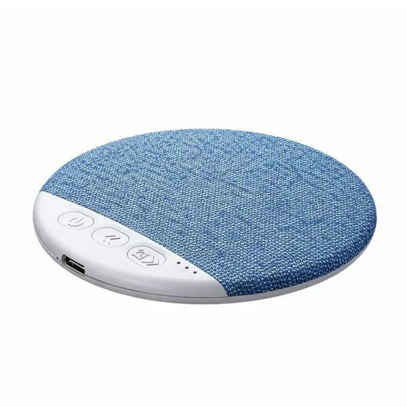 Blue fabric round white noise machine for sleep with control buttons and charging port.