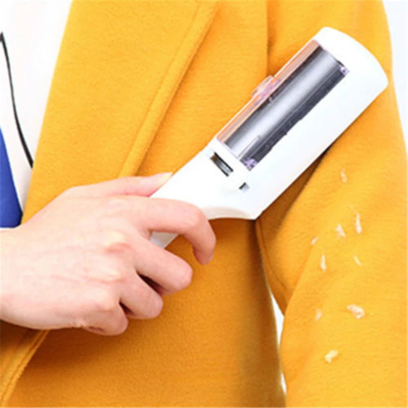 White electrostatic pet hair remover brush cleaning lint and fur from a yellow coat for easy cleaning.