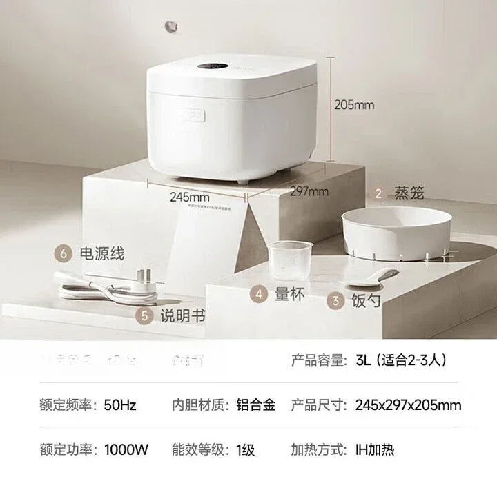 White countertop rice cooker on a stand with measuring cup and rice scoop