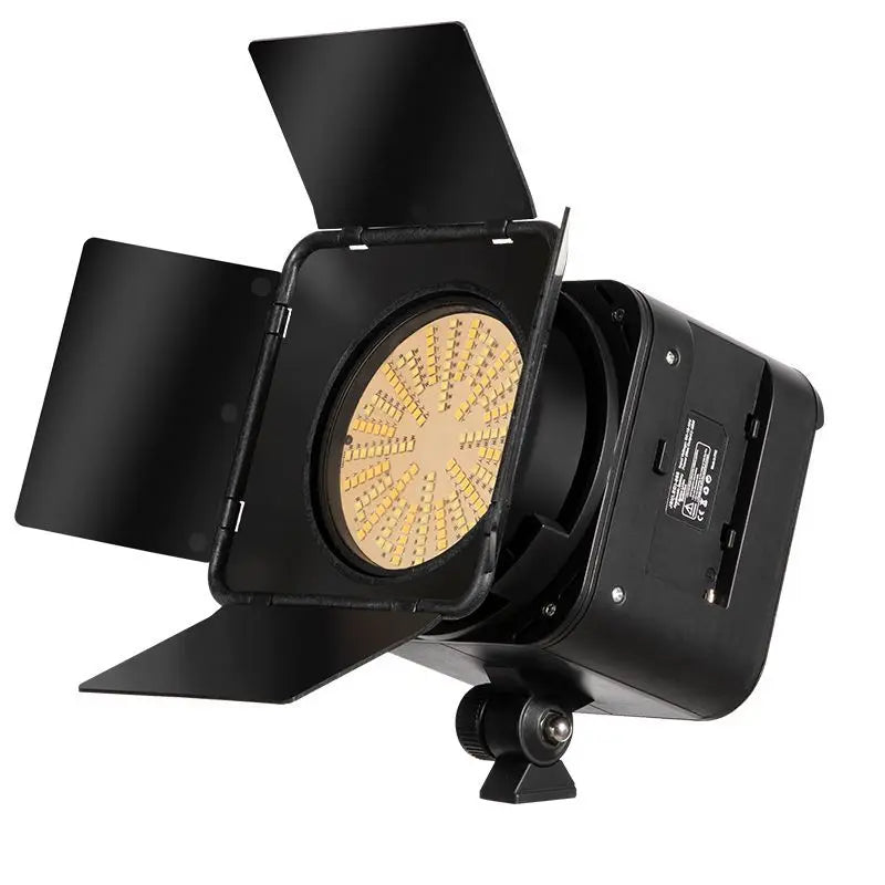 Black LED video light with adjustable metal barn doors and a circular yellow light panel for photography and video.