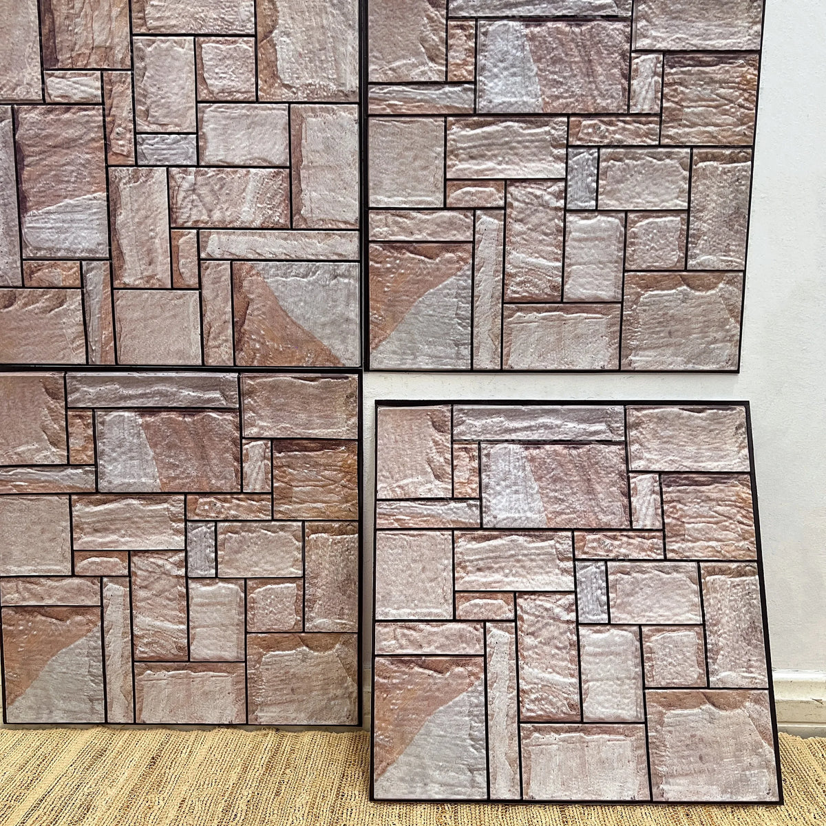 Peel-and-stick faux stone brick backsplash tiles in light beige and taupe