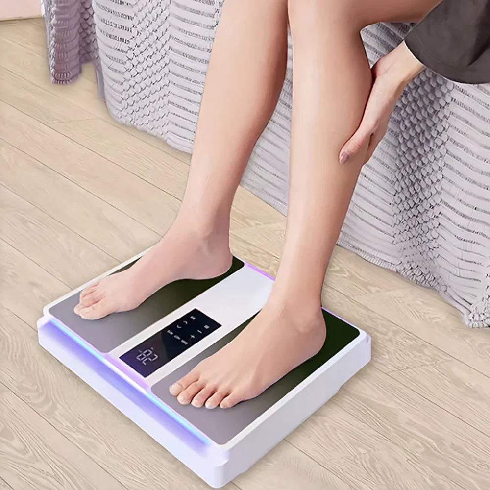 Electric foot massager with a white base, two grey foot pads, and a central digital control panel for legs and feet.