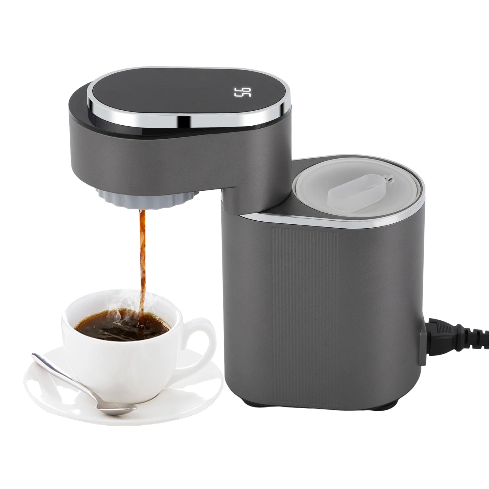 Modern dark gray compact coffee maker with digital temperature display brewing coffee into a white cup.