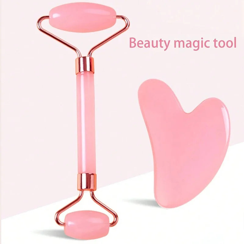 Pink quartz dual-ended facial roller and heart-shaped Gua Sha scraping tool on a light pink background.