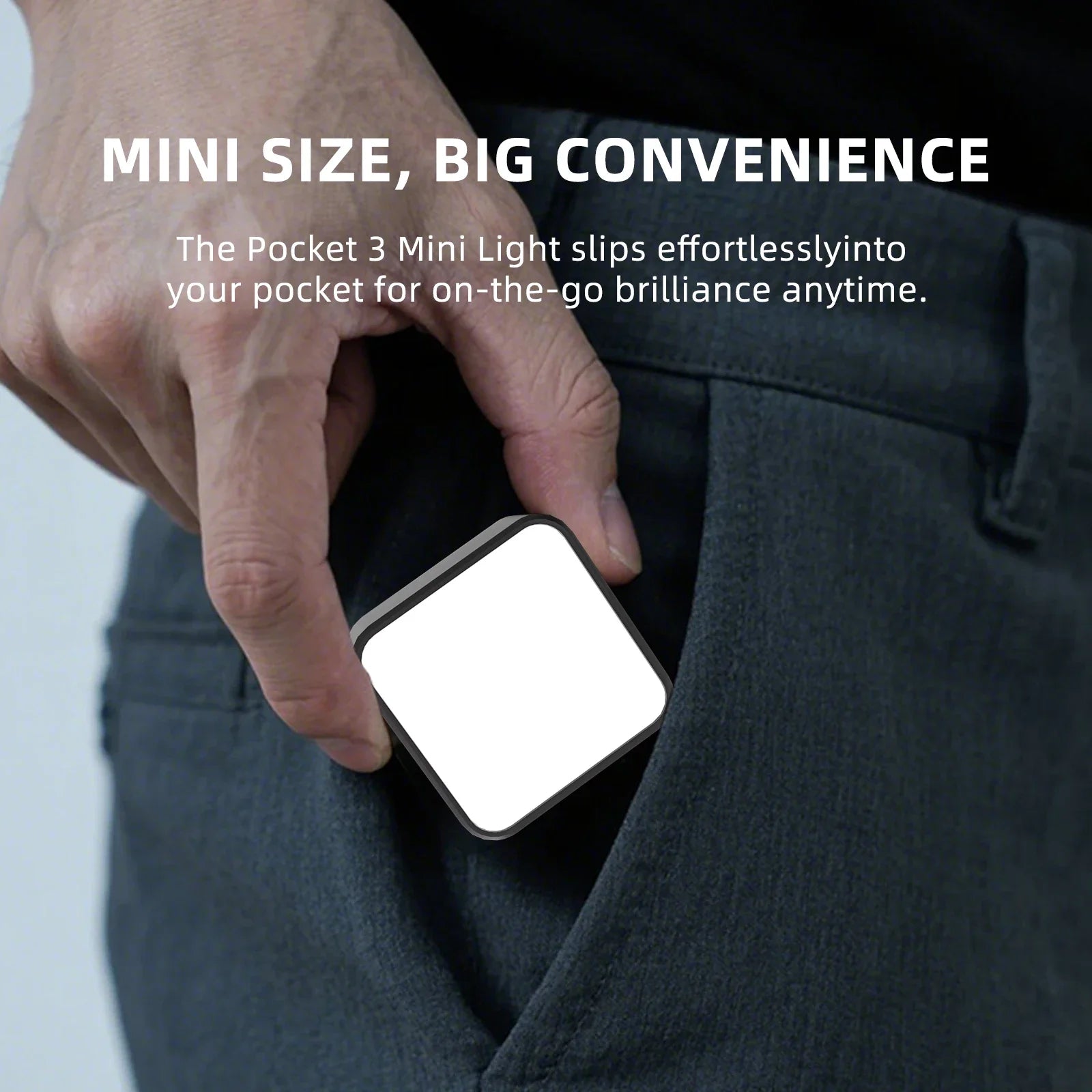 Pocket 3 Mini Light, a small square portable LED with a white face, being placed into a pant pocket.