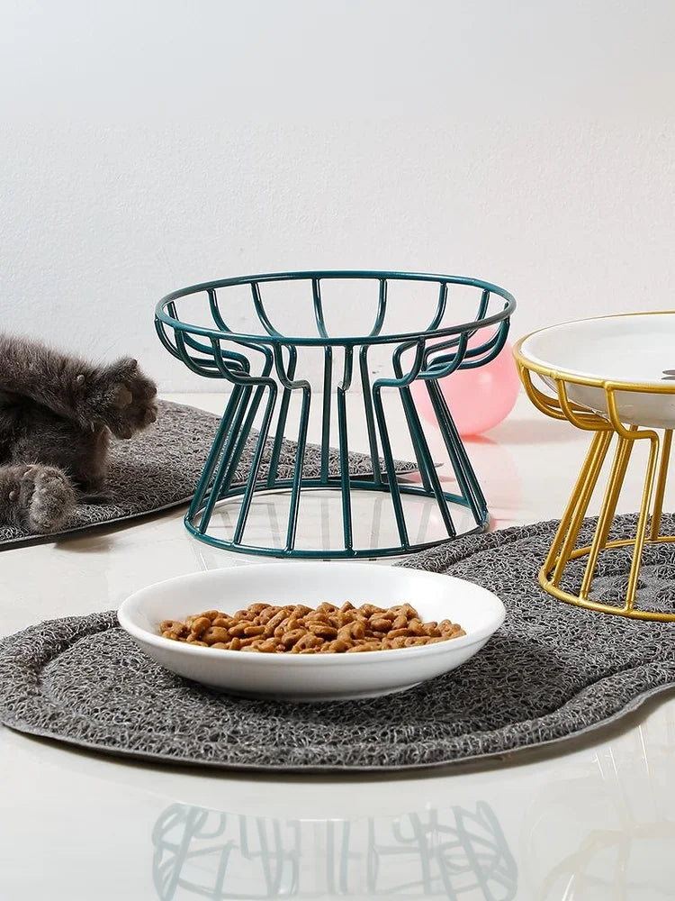 Elevated ceramic cat and dog bowls with teal and gold metal stands for ergonomic feeding.