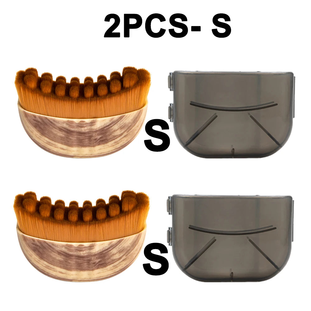 Two small, semi-circular face brushes with tan bristles and wood-look handles, each with a translucent protective cover.