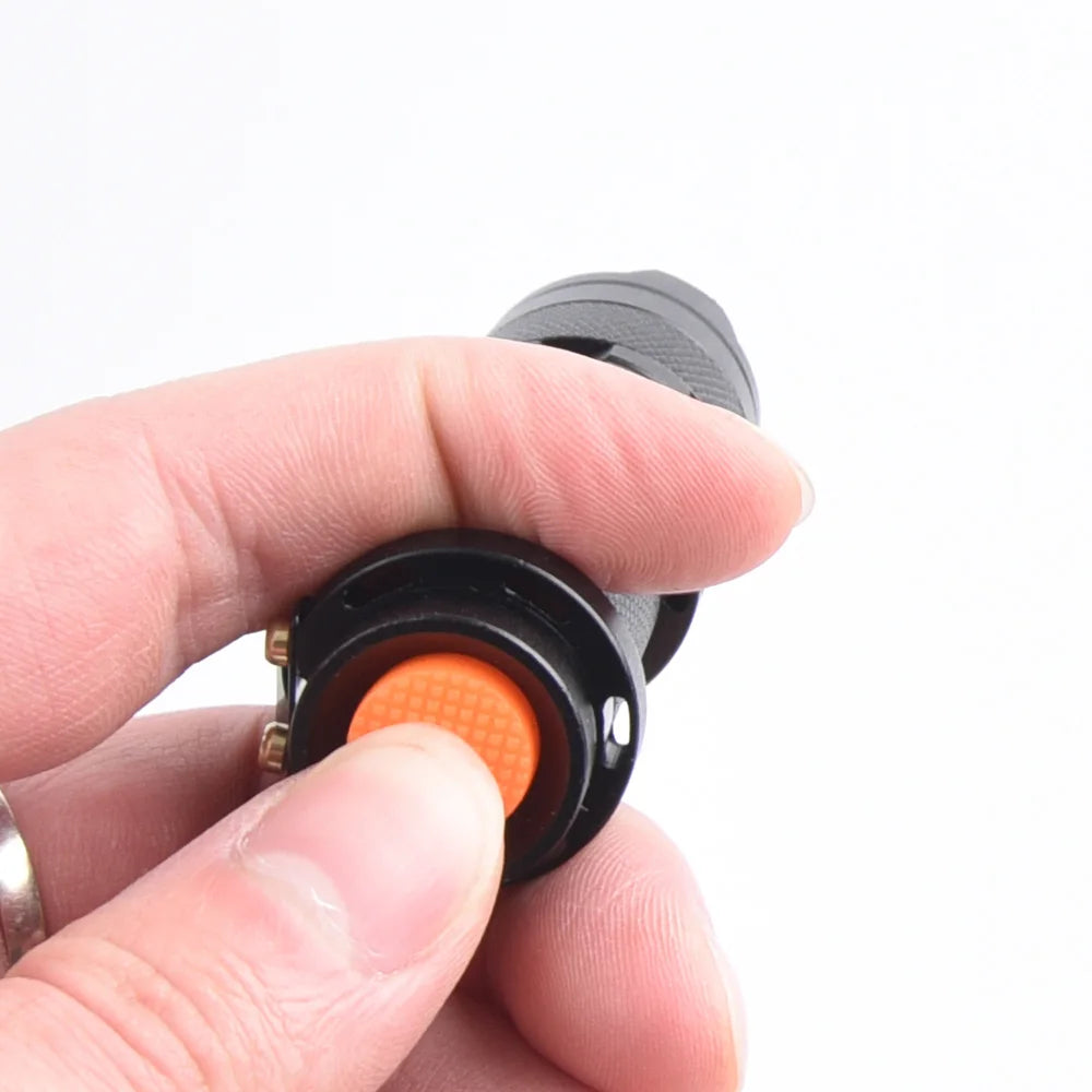 Compact black UV flashlight with orange button for detecting pet urine stains and hidden messes.
