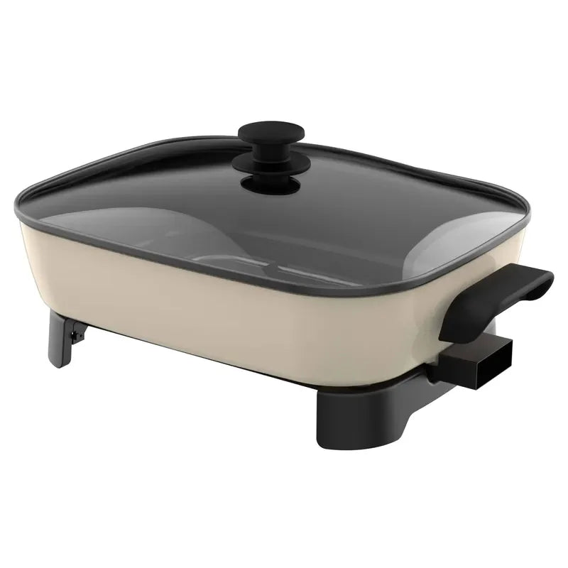 Nonstick electric frying pan with glass lid, black handles, and beige base