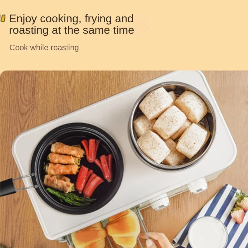Mini 4-in-1 breakfast oven with black skillet and covered steamer pot, open oven window.