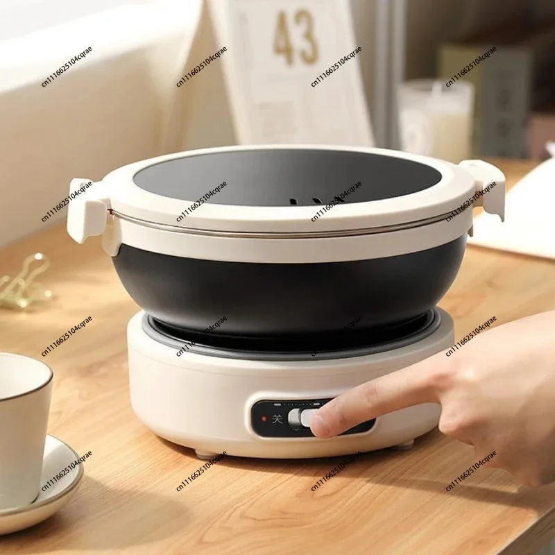 Portable electric cooking pot with white base and black inner pot, round lid attached