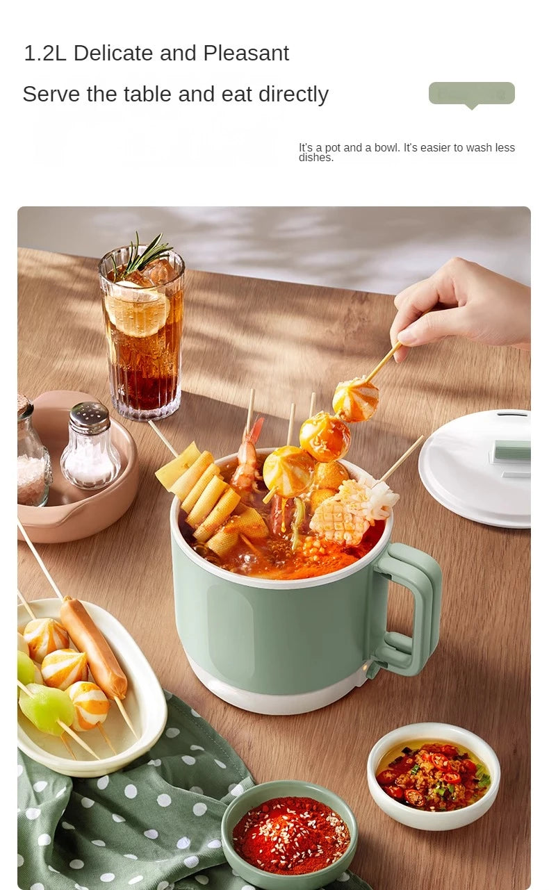 Mint green 1.2L electric hot pot with side handles, filled with red soup and toppings