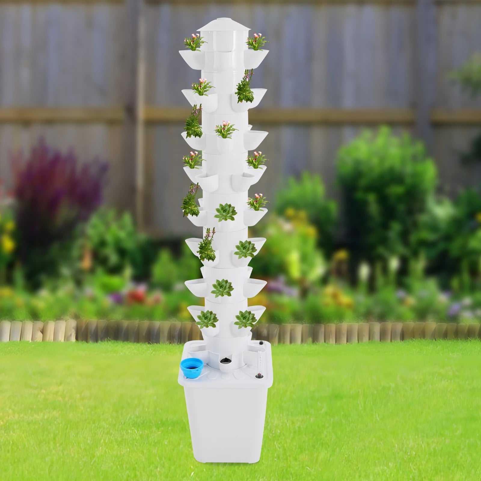 White vertical hydroponic planter tower with multiple small green plants and blue basin