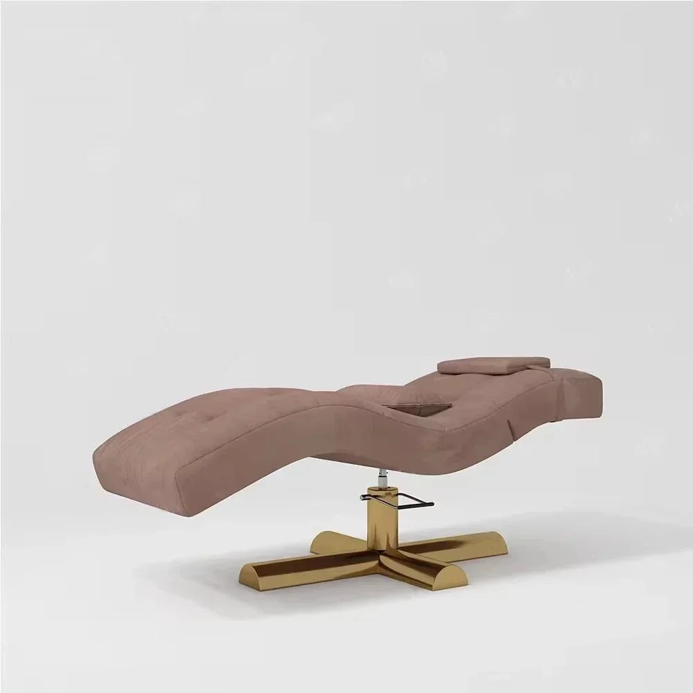 Dusty rose velvet lash bed with a cutout for head placement, on a gold swivel base with a height-adjustment lever.