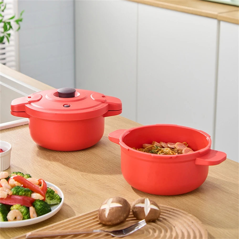 Red microwave pressure cooker pot with lid and another open pot on a countertop