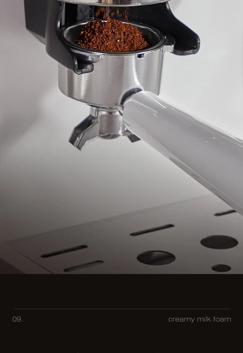 Stainless steel portafilter of espresso machine being filled with fresh ground coffee over a drip tray.
