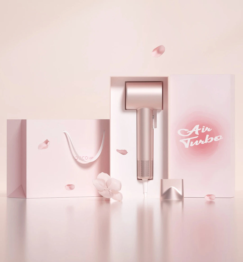 Rose gold DOCO high-speed hair dryer with nozzle attachment in luxury gift box packaging, perfect for hair care travel.