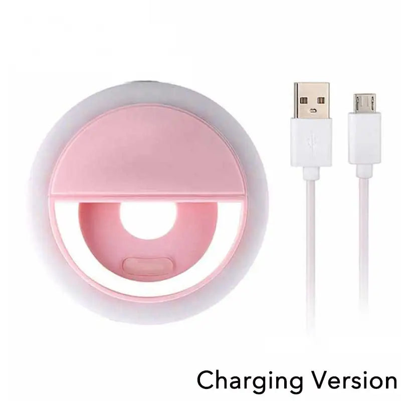 Round pink clip-on selfie ring light with white USB charging cable.