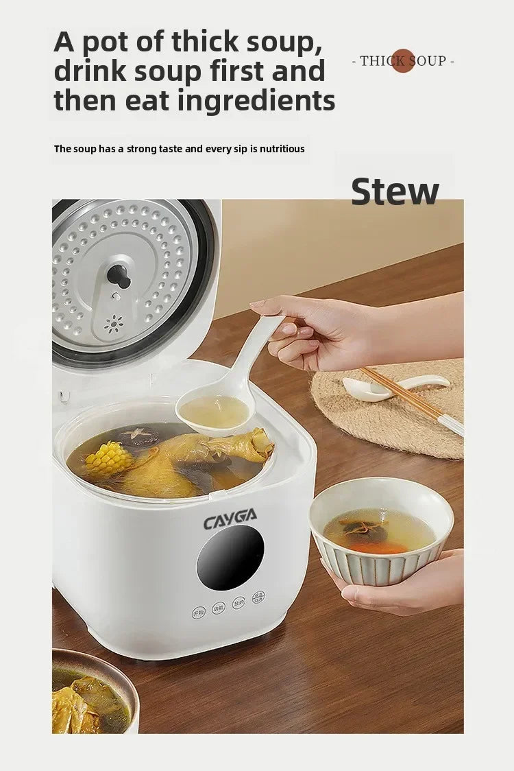 White rice cooker with lid open, steaming soup inside; includes serving bowl and ladle