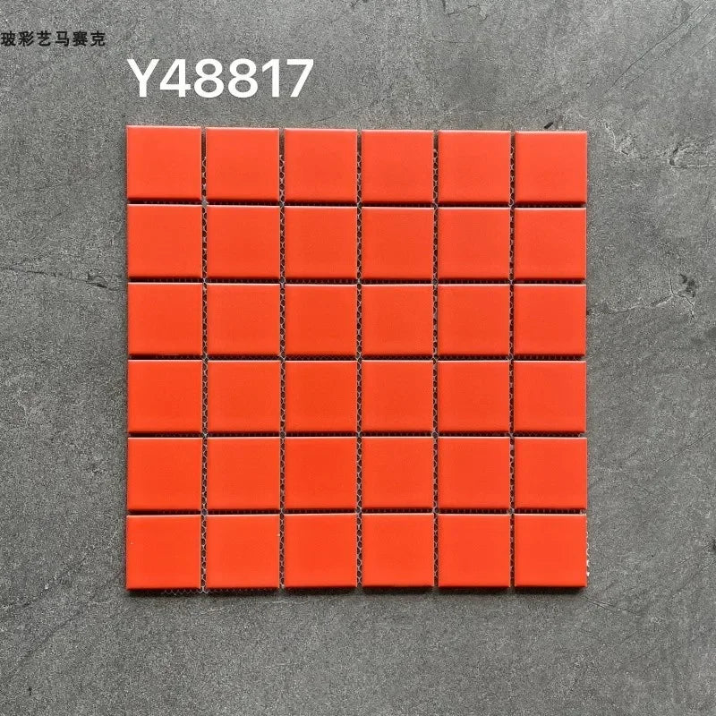 Ceramic mosaic tile sheet with small square orange tiles on grid backing