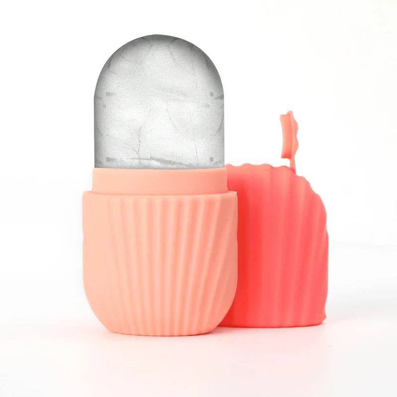 Silicone ice face roller in pastel peach with a textured grip, shown with a matching removable cap against white.