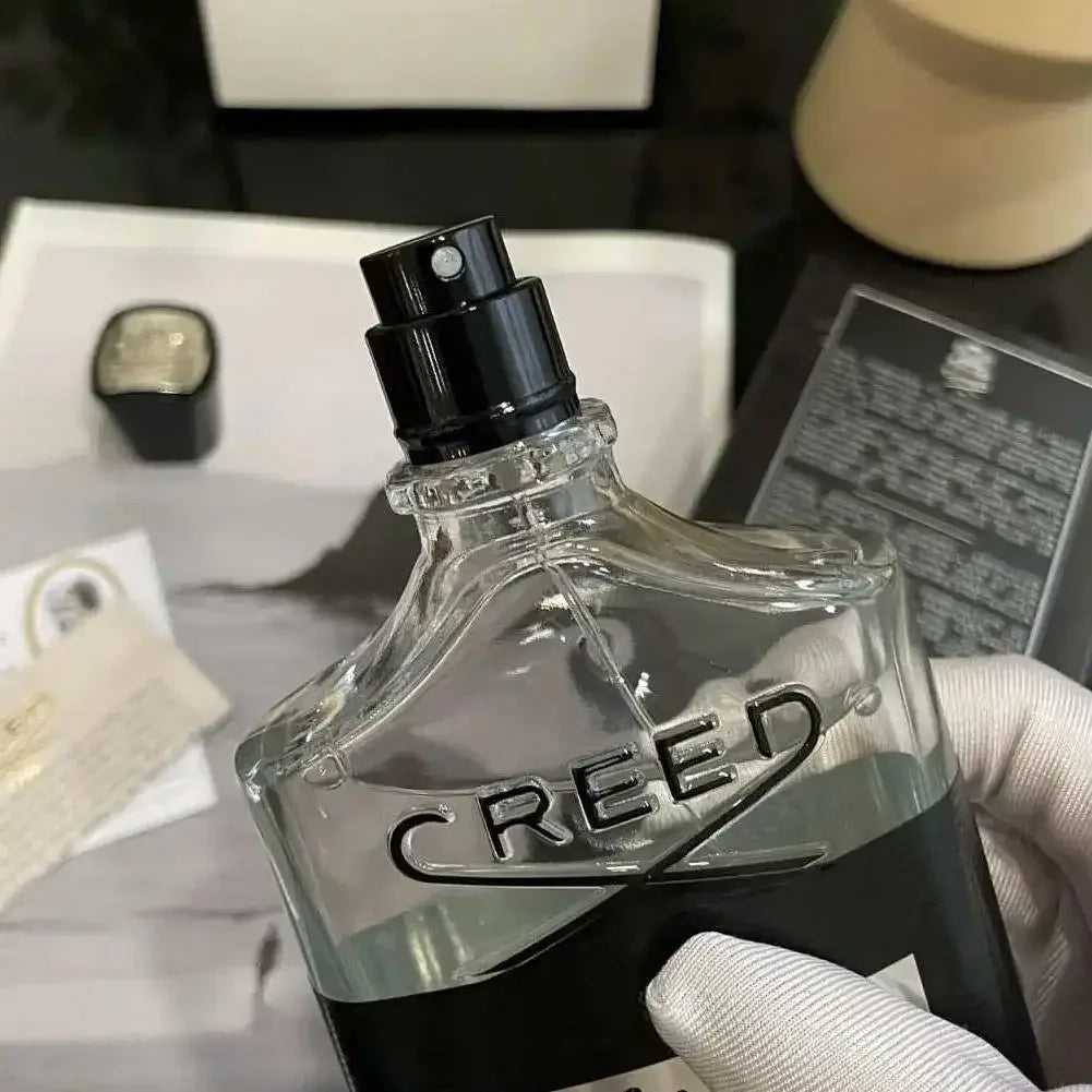 Creed Aventus EDP unisex spray in iconic glass bottle. Authentic luxury fragrance for men and women. Premium scent.