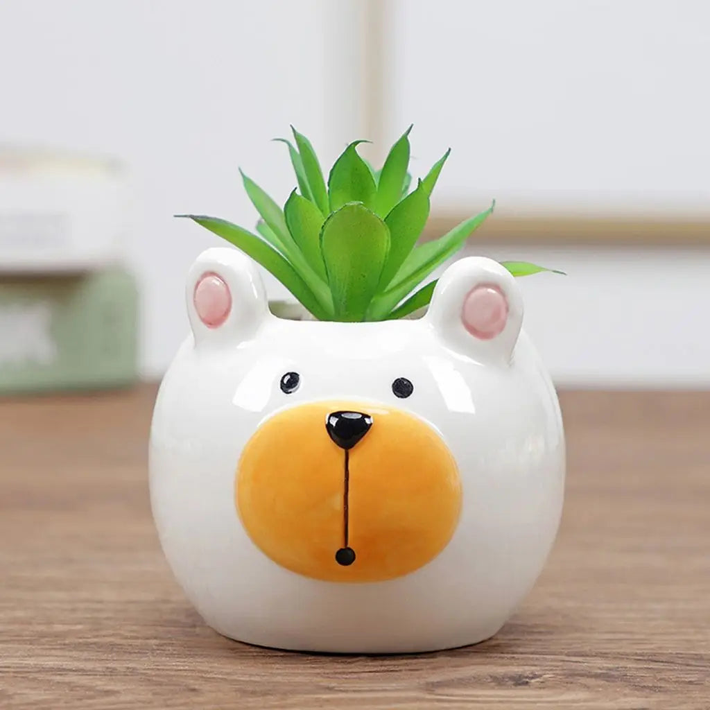 Cute ceramic bear planter with green succulent, orange nose and rounded snout design