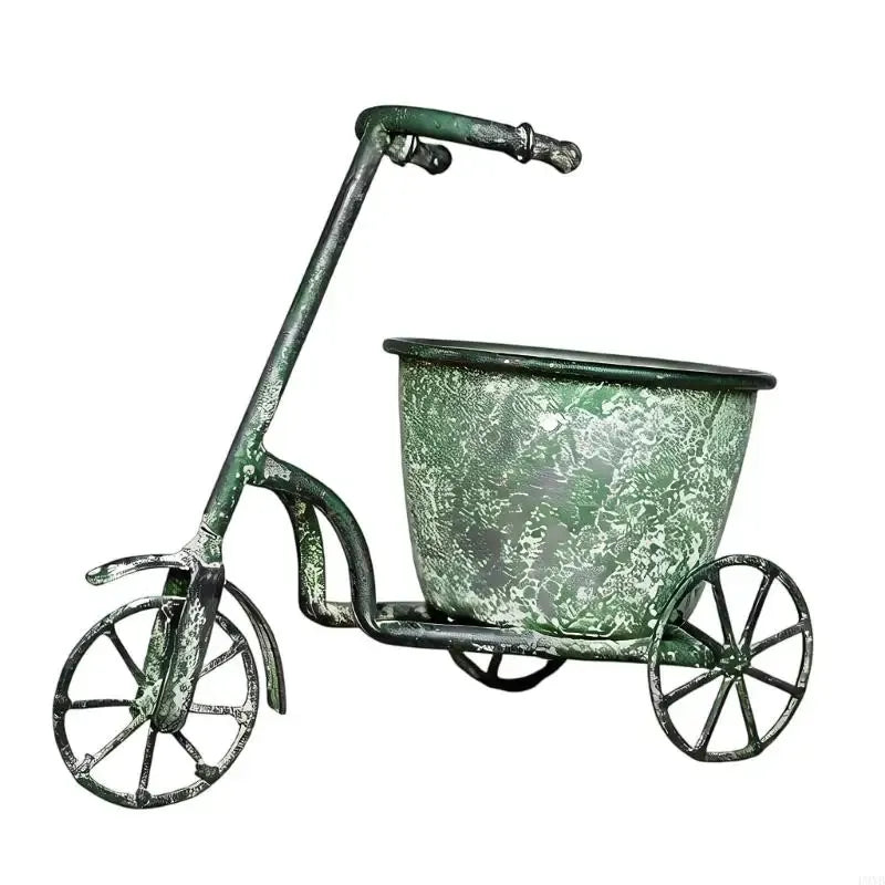 Green speckled wrought-iron style flower pot on three-wheel cart with handle.