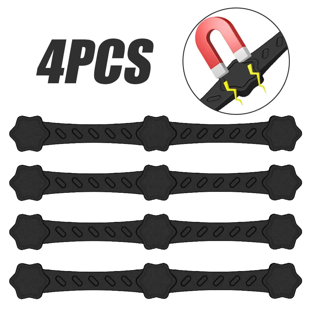 Four black silicone magnetic air fryer parchment holder straps with star grips