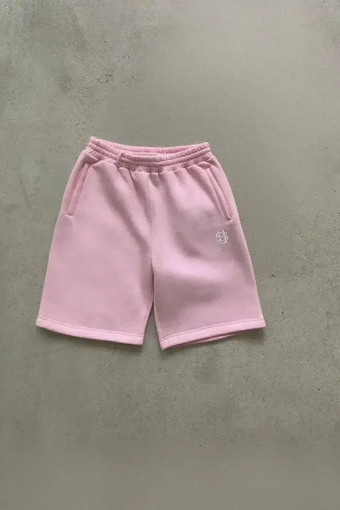 Tidesmit pink cotton jogger shorts with an elastic waistband, side pockets, and a small white embroidered logo.
