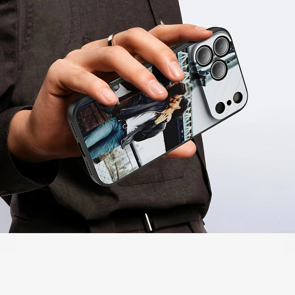 Custom photo-printed iPhone case with a black protective frame and raised camera bumper, held in a hand.