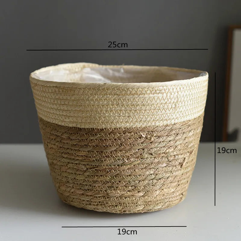 Woven grass planter basket with cream top band and tan lower section, 19cm wide.