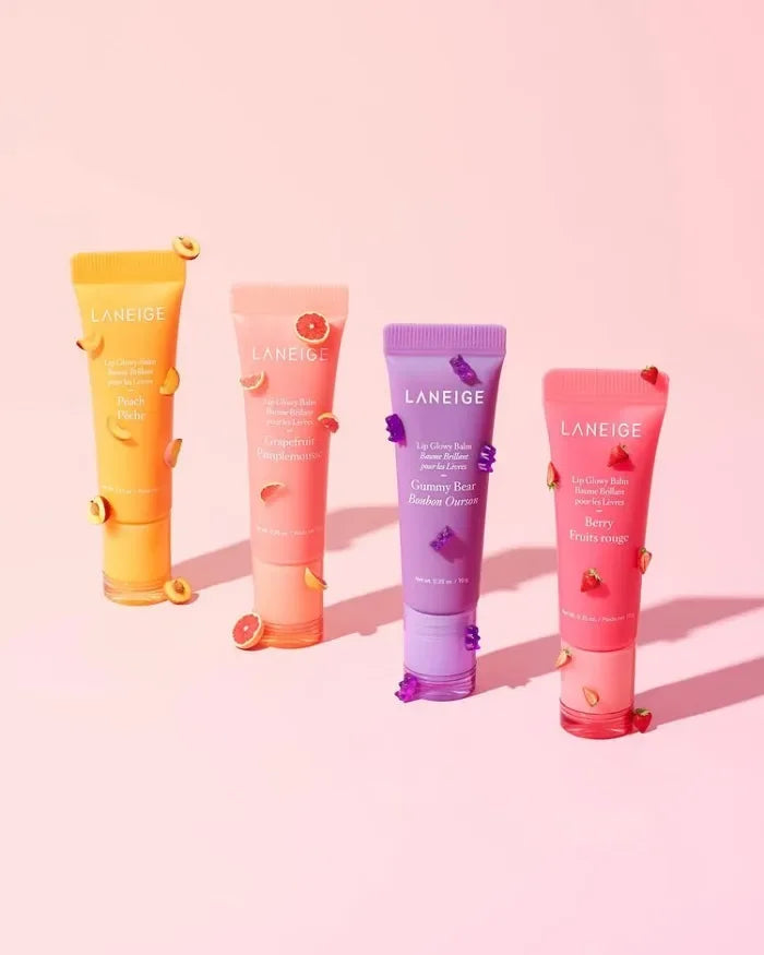 Four Laneige Lip Glowy Balm tubes in Peach, Grapefruit, Gummy Bear, and Berry for smooth, hydrating, glossy lip care.