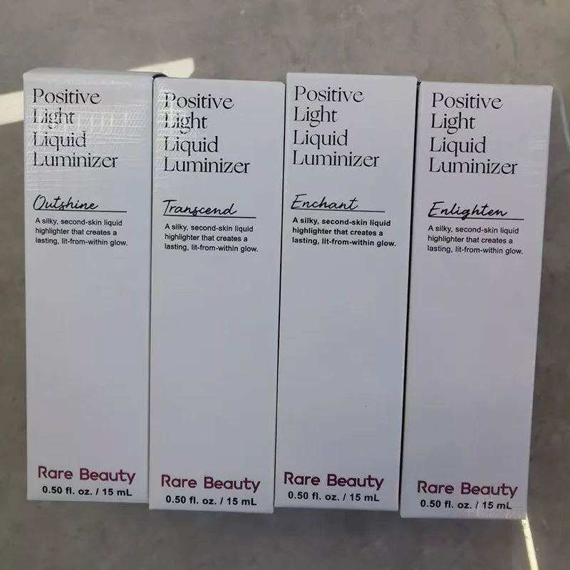 Rare Beauty Positive Light Liquid Luminizer highlighter boxes in Outshine, Transcend, Enchant, and Enlighten shades.