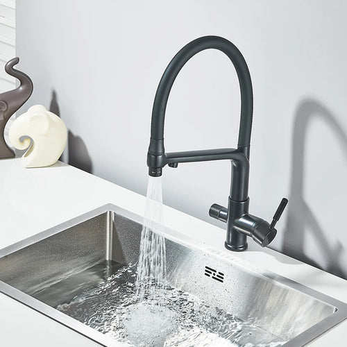 Black kitchen faucet pouring water into stainless sink, dual outlet spouts and lever
