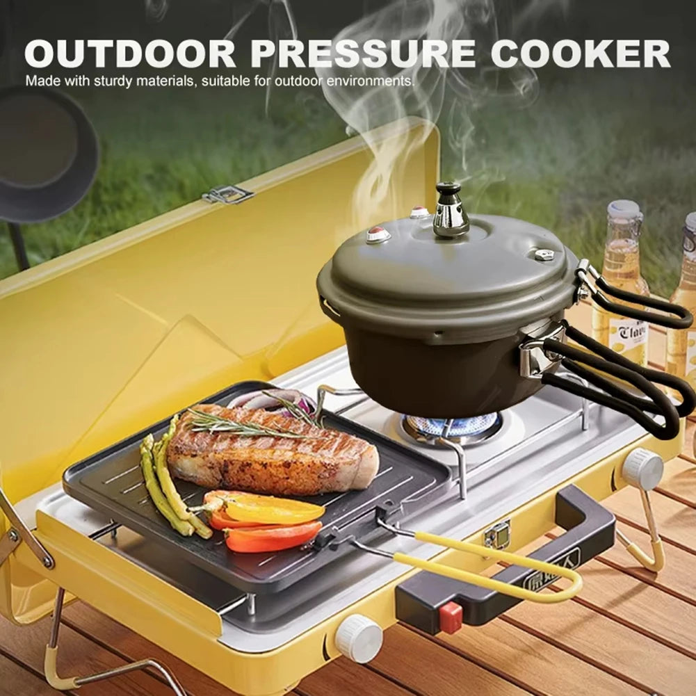 Outdoor pressure cooker on camping grill with vented lid and wire cooking rack