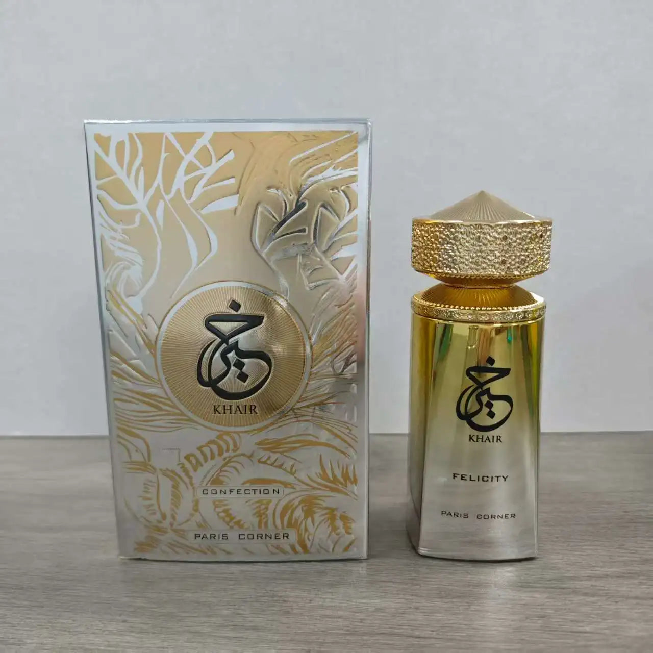 Paris Corner Khair Felicity EDP for women. Gold cylindrical perfume bottle with textured cap and matching gift box.