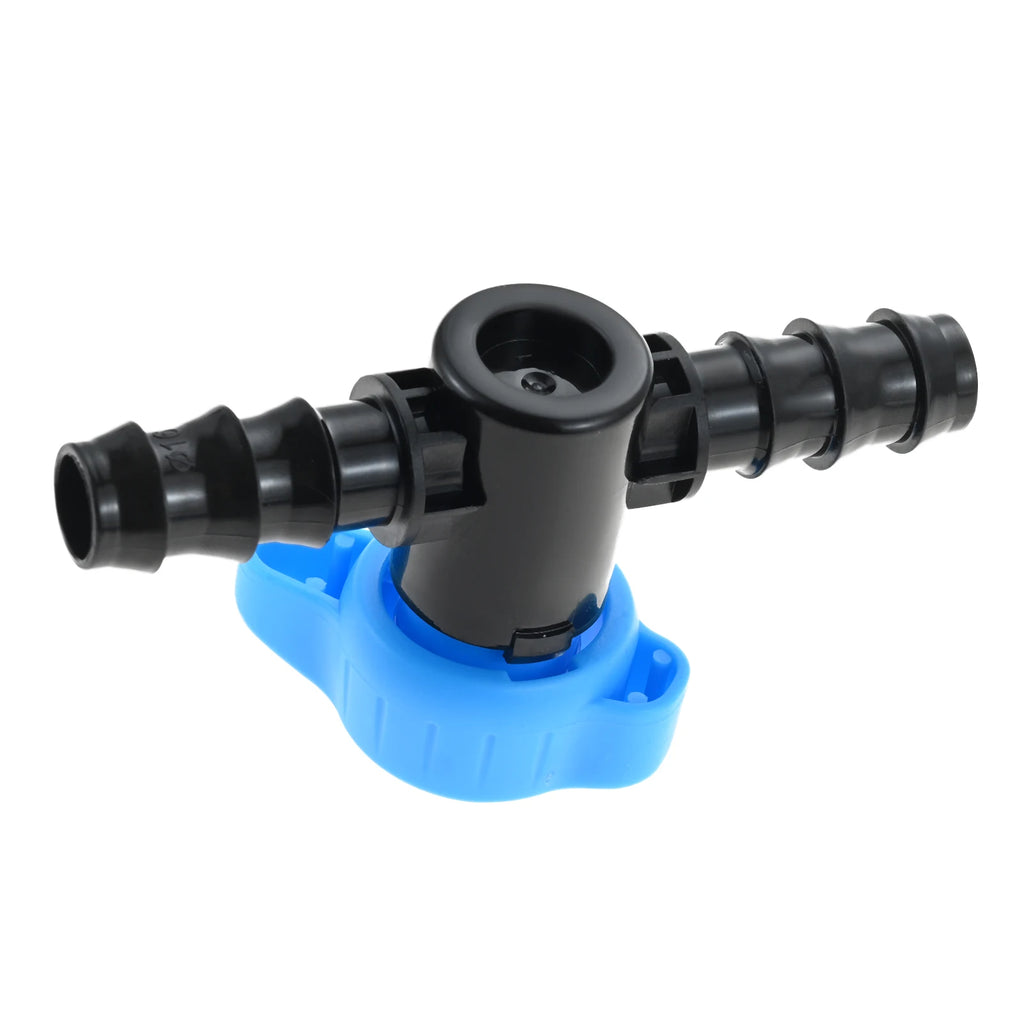 Angled view of a blue-and-black plastic drip irrigation shut off valve with barbed ports