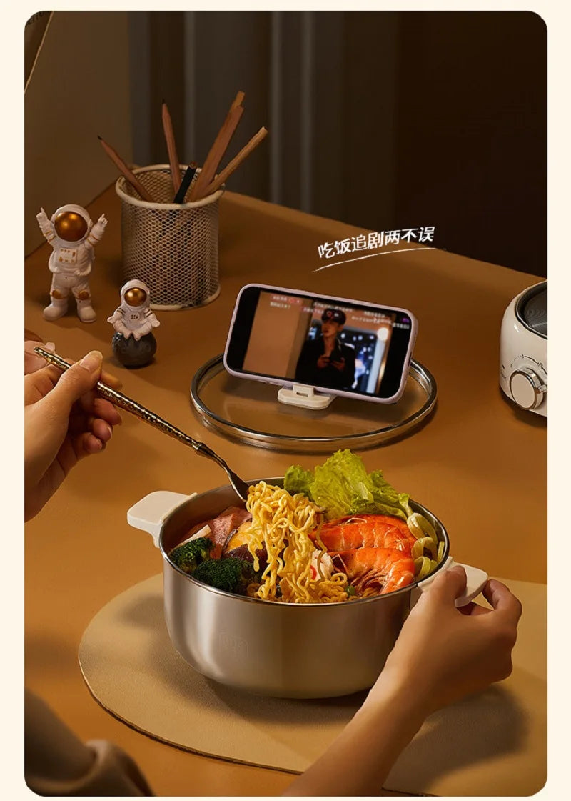 Stainless electric hot pot with lid and side handles, filled with noodles