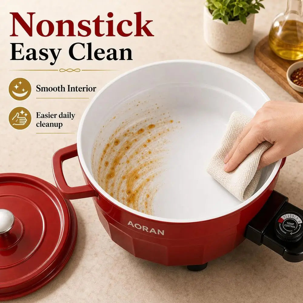Red electric hot pot with white nonstick inner pot, towel wiping the surface